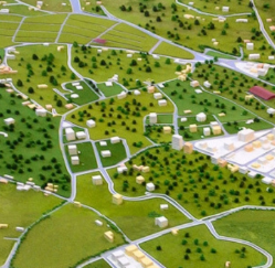 Large interactive model created by ARI Model for Energie & Umwelt Messe with an incorporated renewable energy power generation facility, intelligent grid areas, integration with sunlight, and motion sensor demo zones. Lighting systems illustrate 