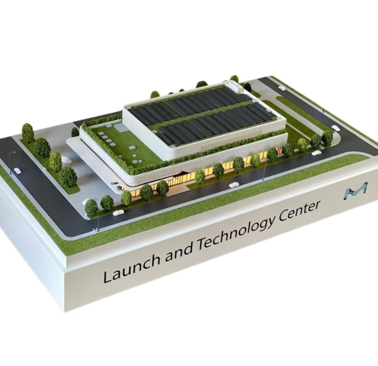 A colorful and tastefully crafted lit up and animated architectural model constructed by ARI Model for an INTERMAT exhibition booth. The model features highly intricate city buildings, construction systems, and power solutions delivered through light